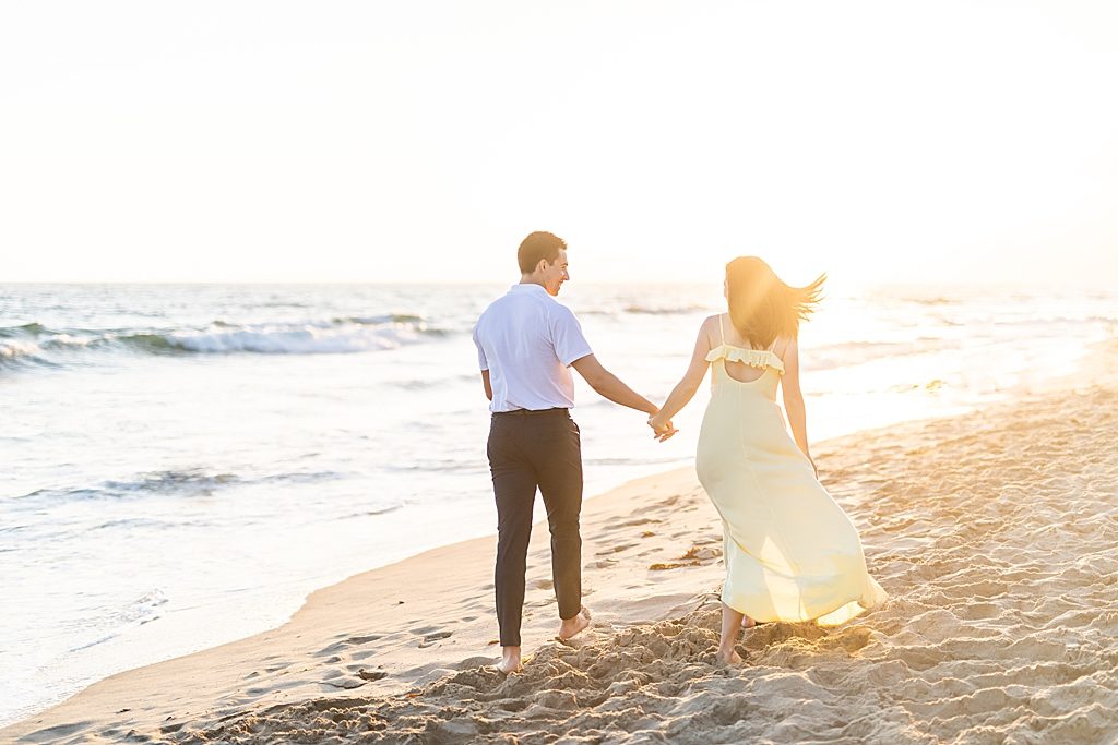 Couple walking on the shore in southern California - Sherr Weddings