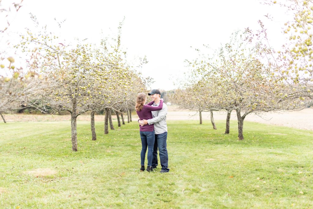 Fall engagement photos of happy couple in big field during sunset in Ohio