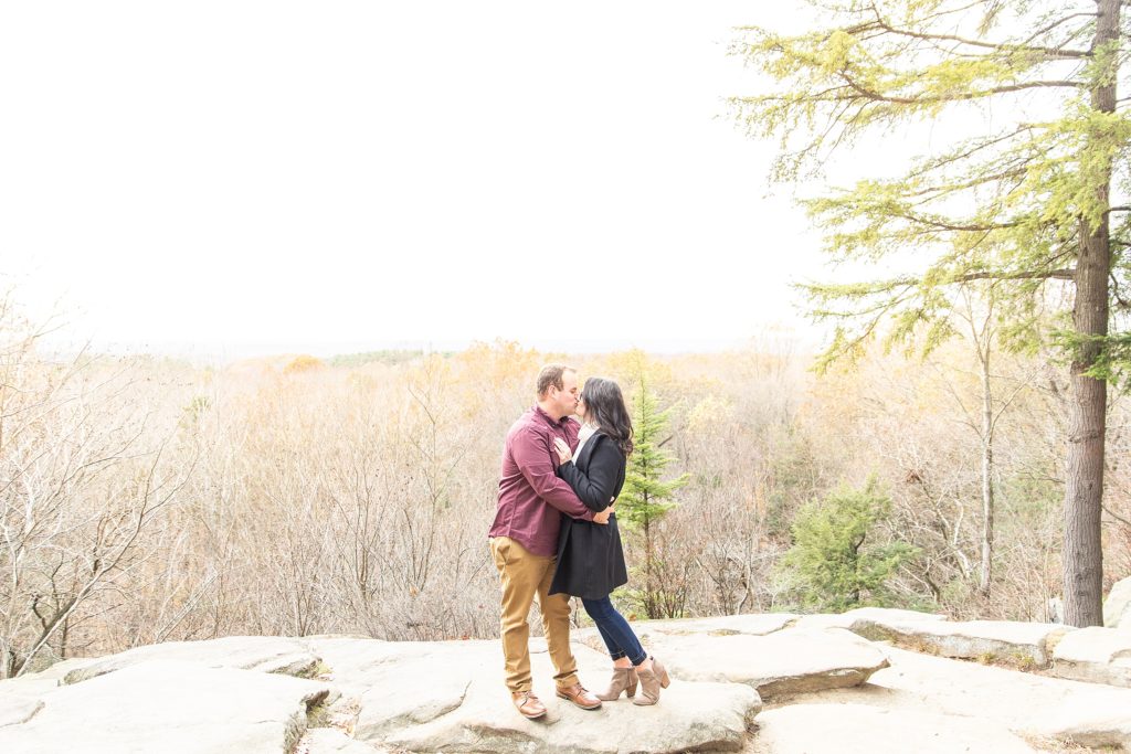 Fall engagement session with couple dancing, kissing, and laughing together at Cuyahoga Valley National Park at sunset