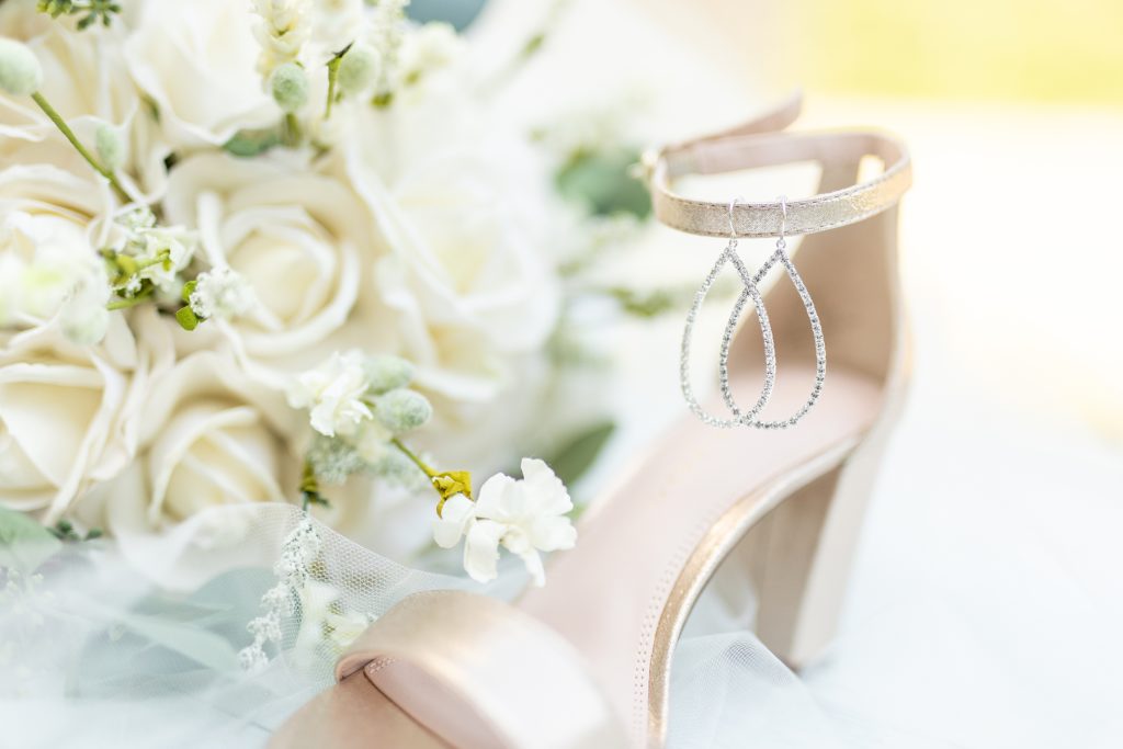 Bride's shoe with earrings and bouquet photographed by Sherr Weddings based in California.