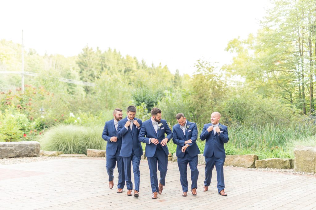 Samantha and Matthew Simko's Hudson, Ohio summer wedding at Highfield Event Center photographed by Bree Thompson Photography serving San Diego Luxury Wedding Photographer. Groom with groomsmen walking photo.