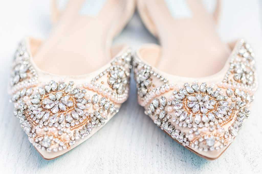 Bride’s shoes and groom’s shoes photographed by San Diego wedding photographer, Bree Thompson.