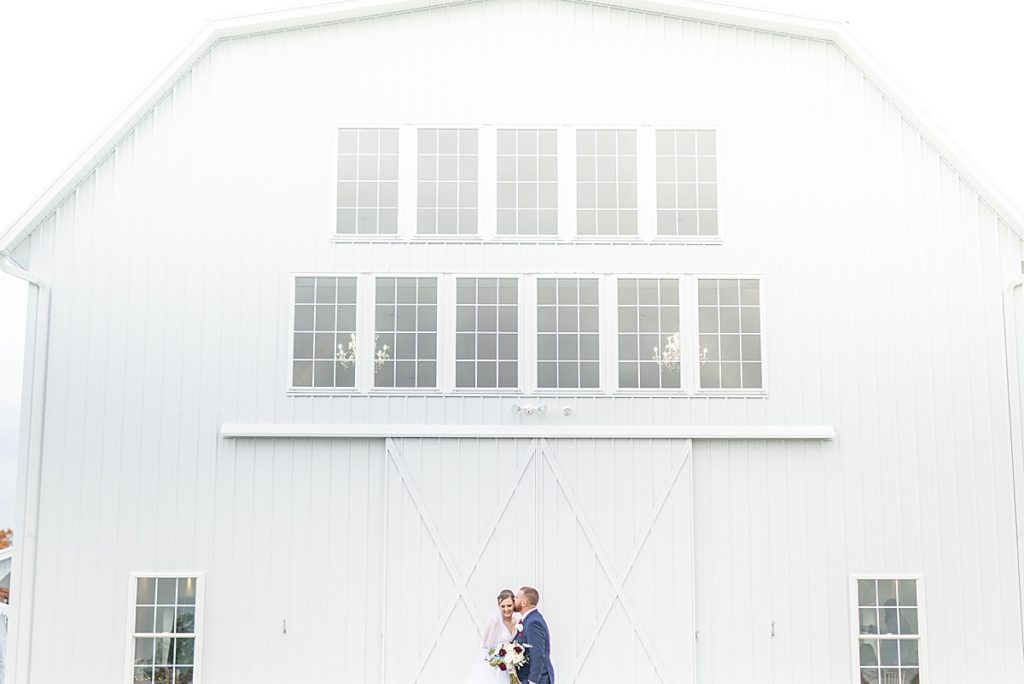 White Rose Barn wedding day details such as perfume, necklaces, shoes, earrings, wedding gown, and bouquet, by wedding photographer, Bree Thompson.