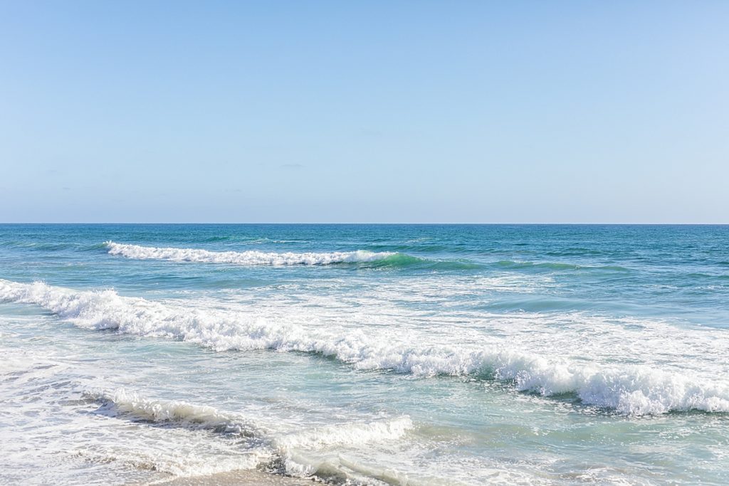 The ocean waves at Carlsbad beach in San Diego, California by Sherr Weddings.
