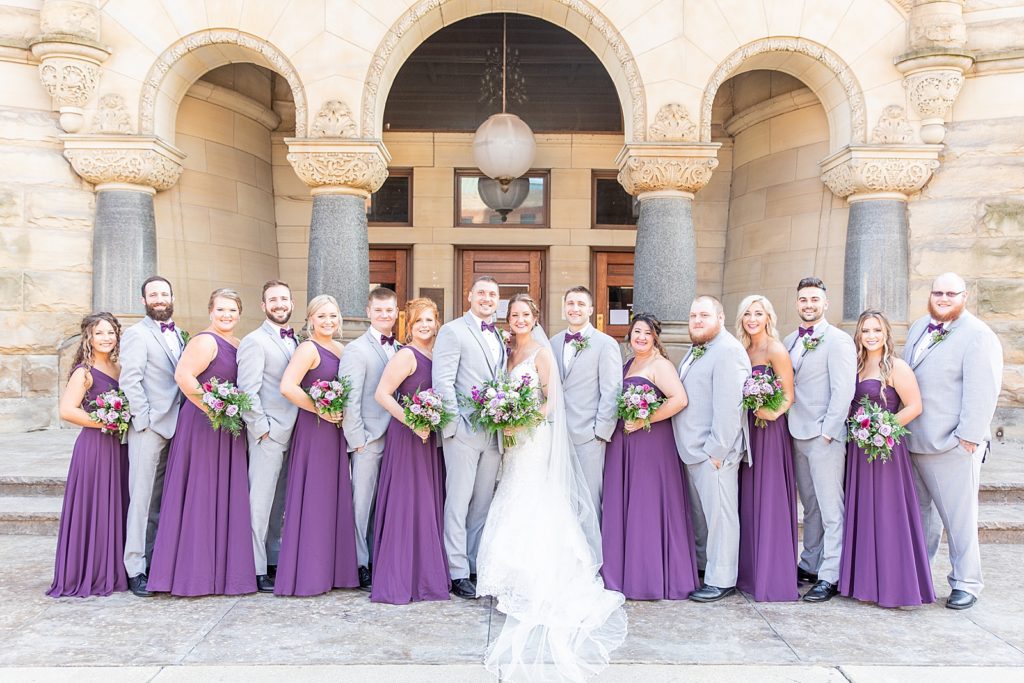 Dark purple bridesmaids dresses from David’s bridal and bride’s dress from Evaline’s Bridal. Groom and Groomsmen suits from Men’s Wearhouse in Pittsburgh, Pennsylvania.
