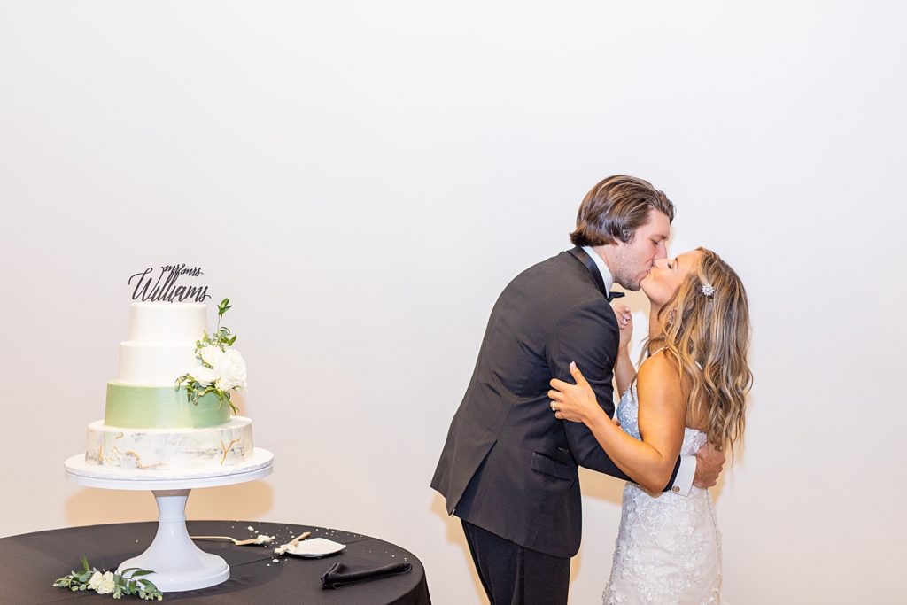 Bride and Groom, Kristen & Dylan Williams kissing on wedding day by Sherr Weddings.