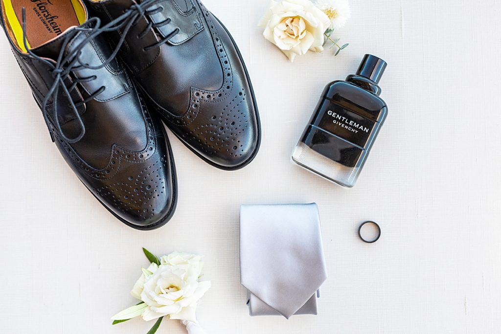 Groom's shoes, givenchy cologne, tie, and wedding ring.