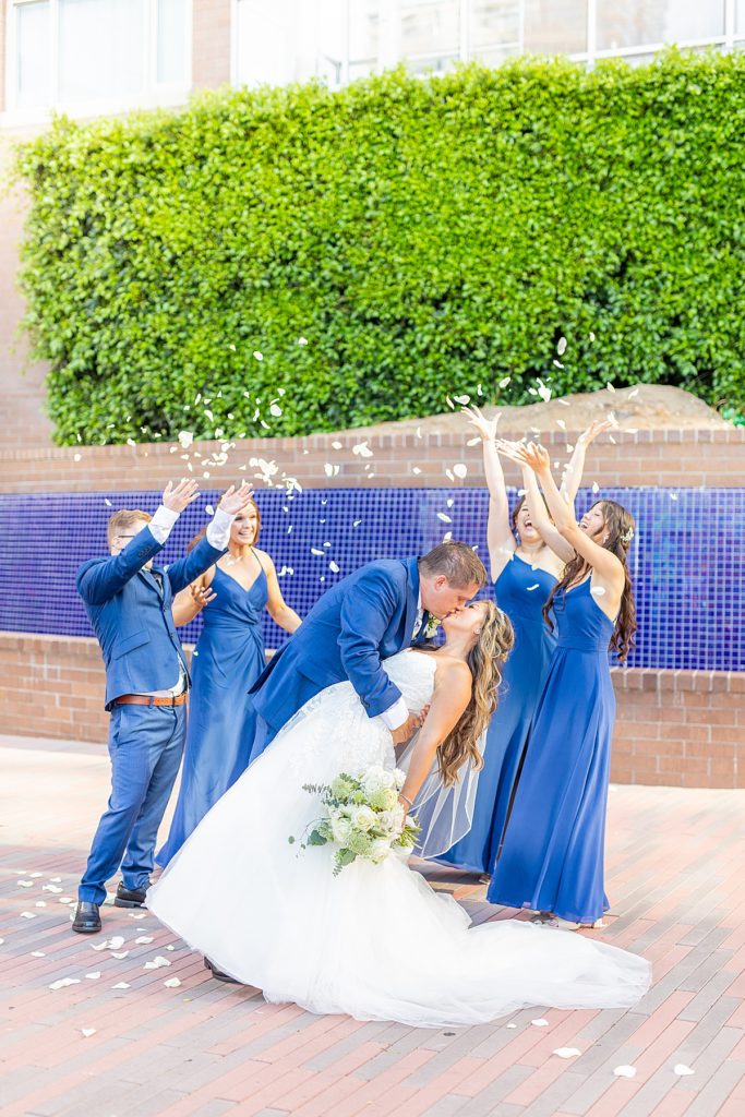 Wedding party throwing rose petals in downtown San Diego.