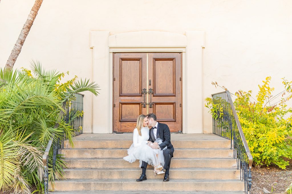 Engaged couple sitting on steps by the lily pond at Balboa Park photographed by Sherr Weddings.