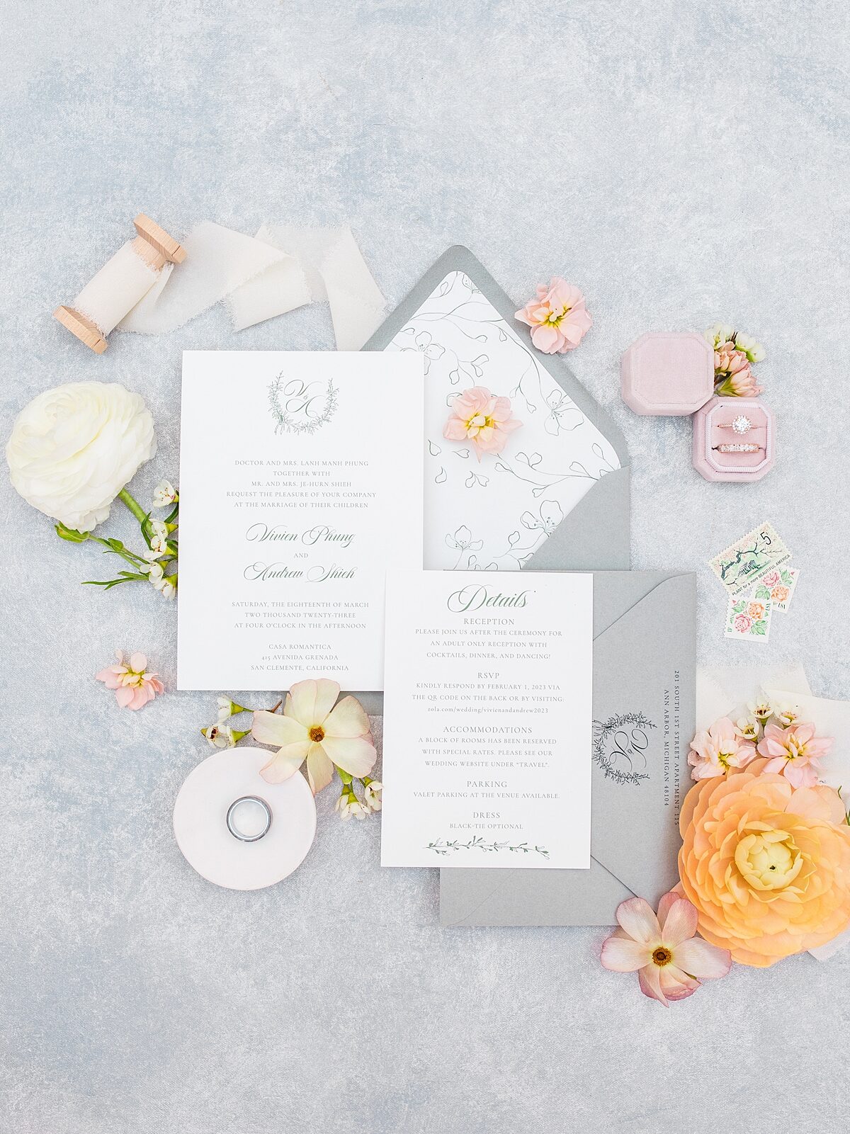Wedding invitation suite with groom and bride's wedding rings and florals at Casa Romantica in San Clemente, California.