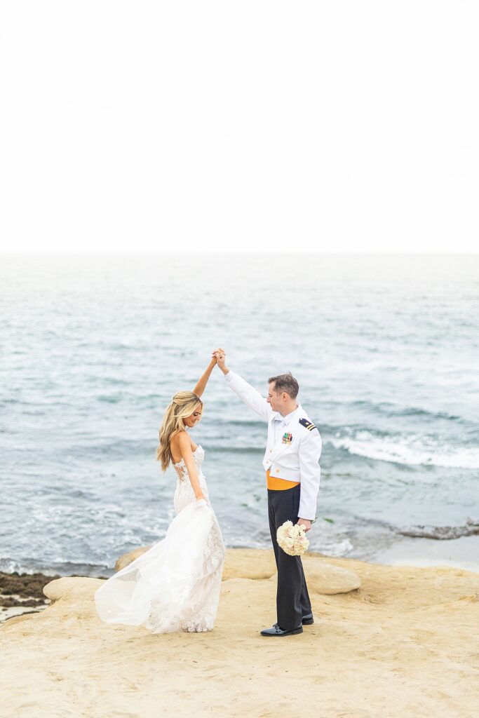 Bride and groom dancing on the cliffs of La Jolla Shores.