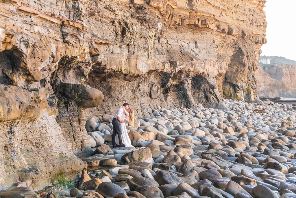 Couple kissing and laughing in Point Loma, California.