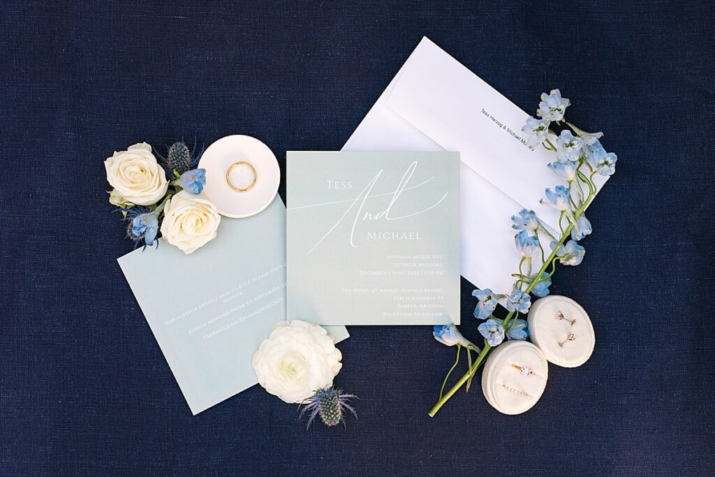 Wedding invitations with wedding rings and florals by Sherr Weddings.