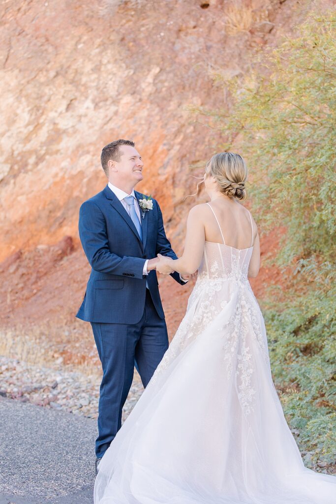 Groom reacting to bride during their first look in Parker, Arizona.
