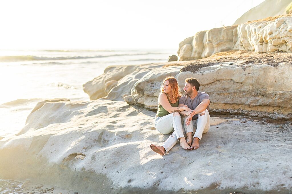 Couple sitting on the rocks at Terramar Beach.