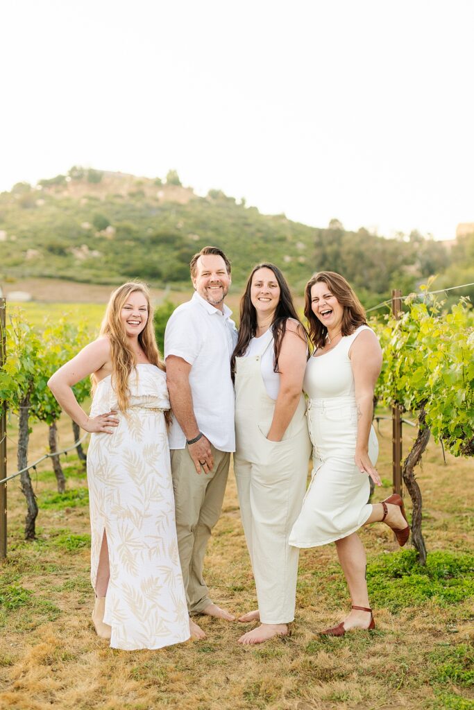 Dad and daughters in vineyard at family photography session.