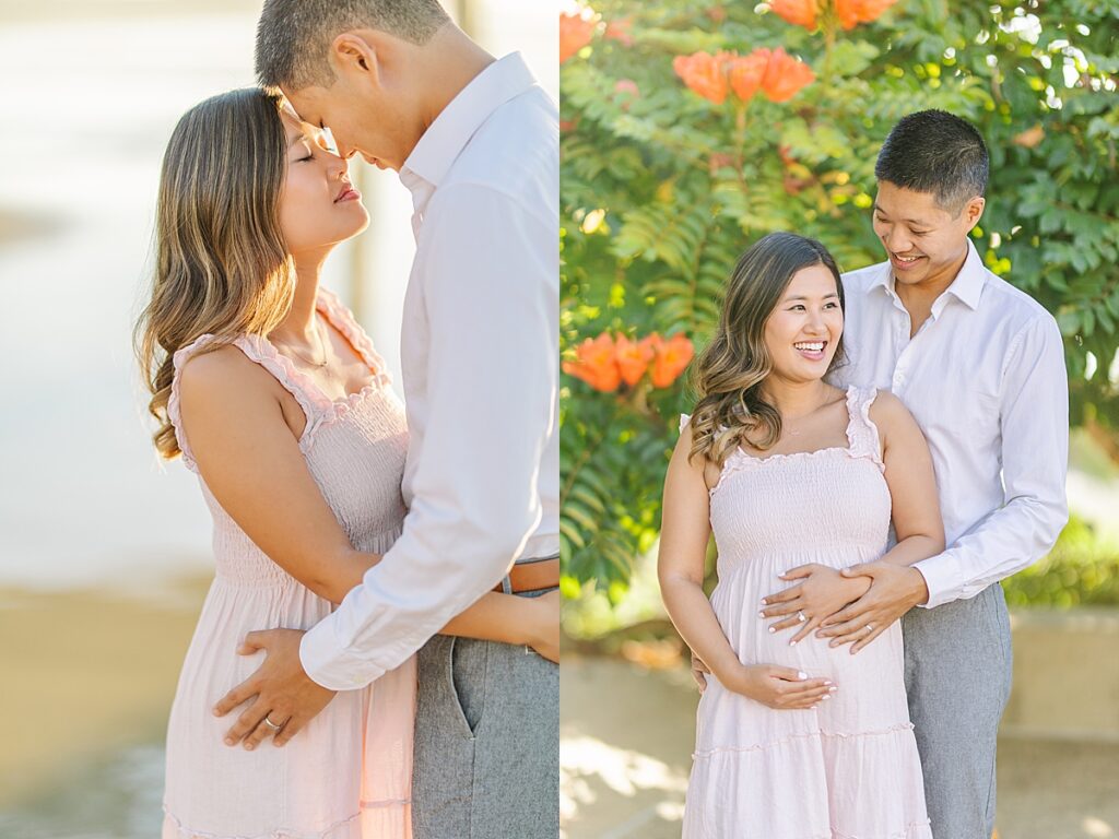 Maternity photos of an Asian couple at Scripps Pier in La Jolla. The expectant mother wears a pink ruffled dress, while the father-to-be is dressed in a white button-down shirt and pants. They’re standing on the beach, surrounded by soft, golden light.