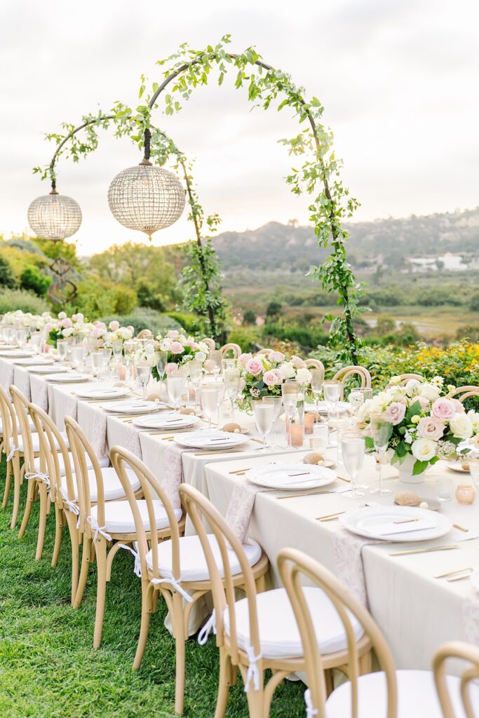 Private residence reception tablescape with hanging crystal lights and blush details in Rancho Sante Fe, California.