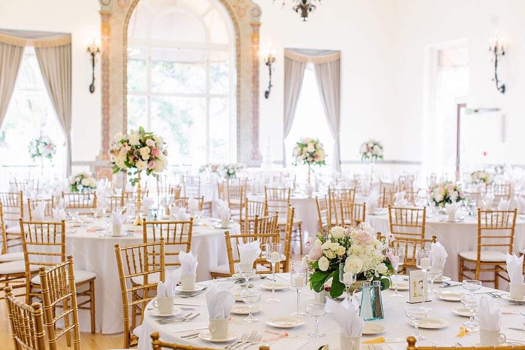 Bride Bailey walks down the aisle surrounded by lush greenery at Hotel Del Monte in Monterey.