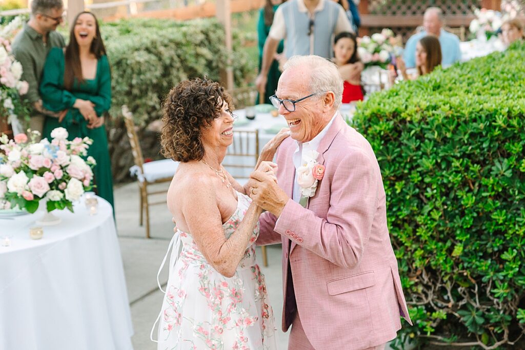 Bride and groom dancing together at their private residence wedding reception in Laguna Hills, California.