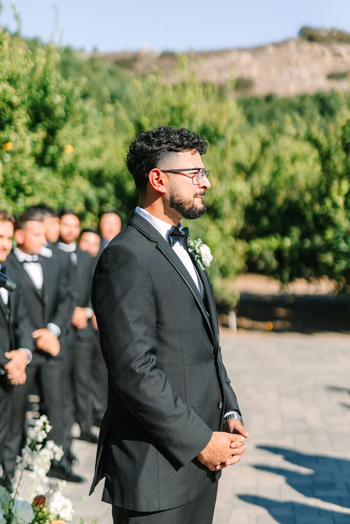 Groom crying seeing his bride for the first time during the wedding ceremony at Rancho Guejito Vineyard in Escondido.