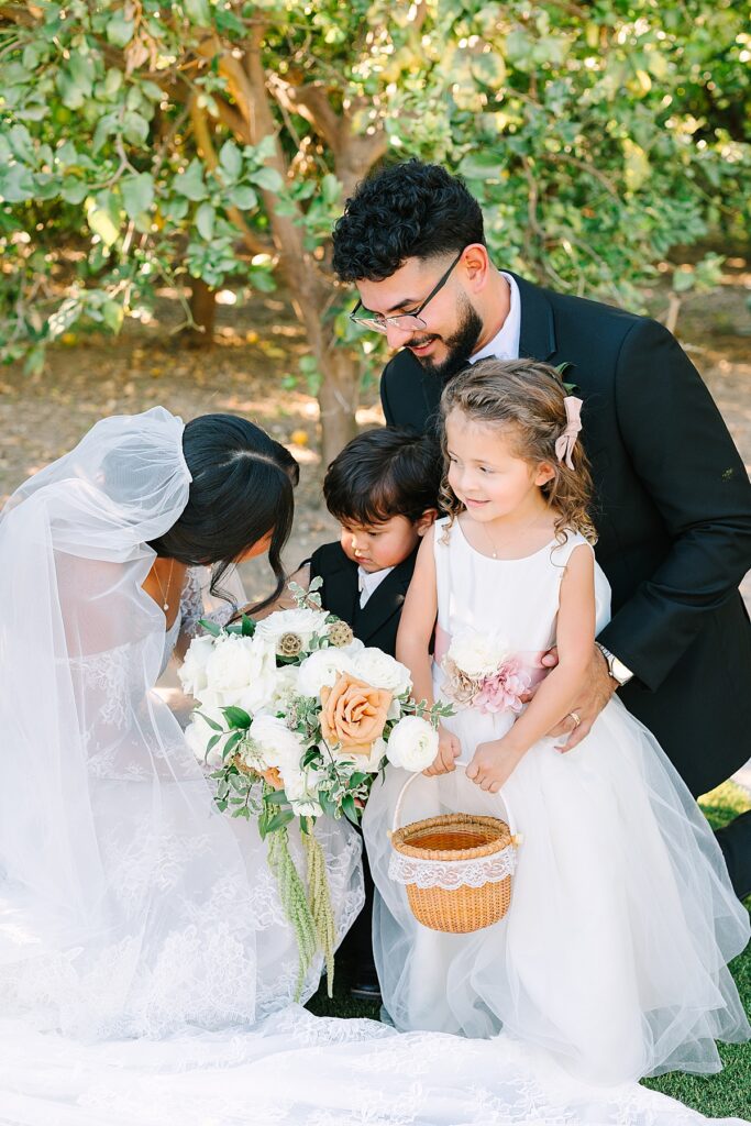Bride and groom having a moment with their niece and nephew (flower girl and ring bearer).